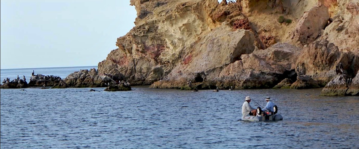 Fishing near some colorful rock formations